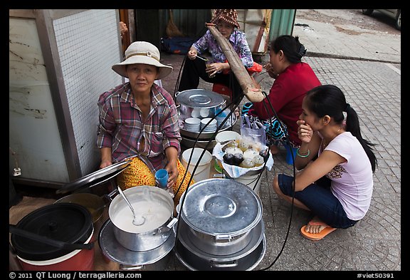 Woman offering soft tofu on the street. Ho Chi Minh City, Vietnam (color)