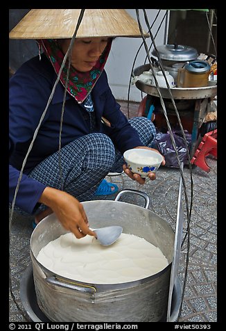 Woman serving a bowl of soft tofu. Ho Chi Minh City, Vietnam (color)