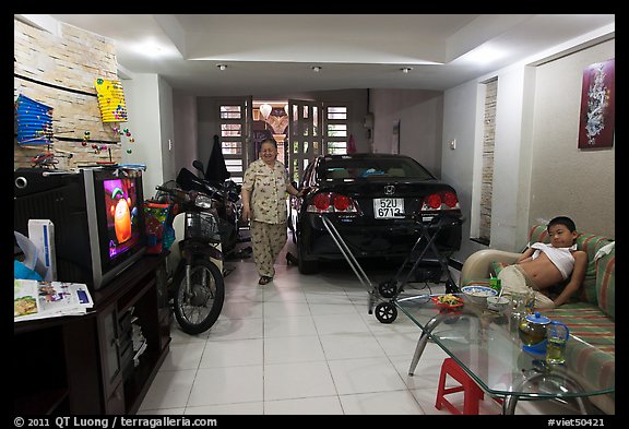 Living room used as car and motorbike garage. Ho Chi Minh City, Vietnam (color)