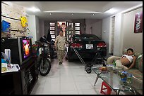 Living room used as car and motorbike garage. Ho Chi Minh City, Vietnam (color)