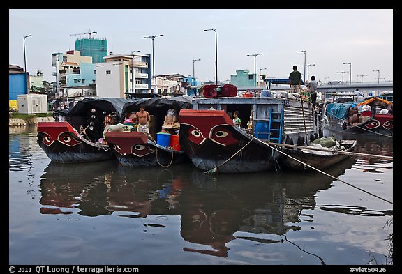 Mariners on freight boats with traditional painted eyes, Saigon Arroyau. Cholon, Ho Chi Minh City, Vietnam (color)