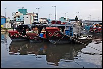 Mariners on freight boats with traditional painted eyes, Saigon Arroyau. Cholon, Ho Chi Minh City, Vietnam (color)