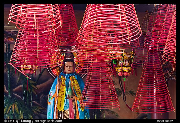 Porcelain figure and incense coils, Phuoc An Hoi Quan Pagoda. Cholon, District 5, Ho Chi Minh City, Vietnam (color)