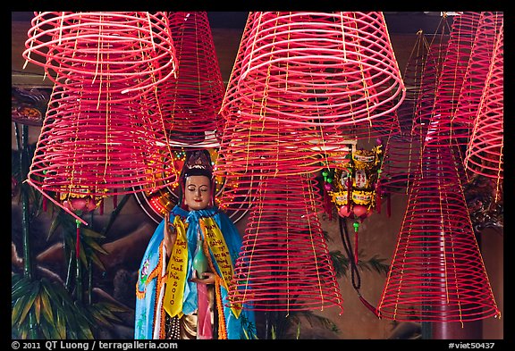 Porcelain figure and incense coils, Phuoc An Hoi Quan Pagoda. Cholon, District 5, Ho Chi Minh City, Vietnam