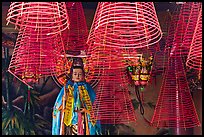 Porcelain figure and incense coils, Phuoc An Hoi Quan Pagoda. Cholon, District 5, Ho Chi Minh City, Vietnam (color)