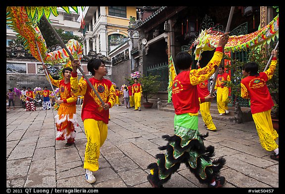 Dancers carry dragon on poles, Thien Hau Pagoda. Cholon, District 5, Ho Chi Minh City, Vietnam (color)