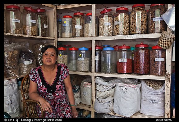 Woman with jars of traditional medicinal supplies. Cholon, Ho Chi Minh City, Vietnam (color)