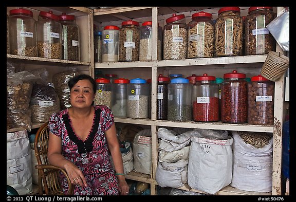 Woman with jars of traditional medicinal supplies. Cholon, Ho Chi Minh City, Vietnam