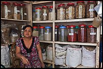 Woman with jars of traditional medicinal supplies. Cholon, Ho Chi Minh City, Vietnam