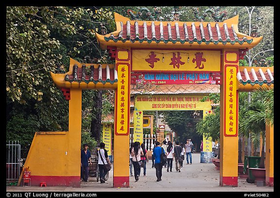 People walking through gates, Giac Lam Pagoda, Tan Binh District. Ho Chi Minh City, Vietnam (color)