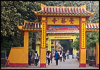 People walking through gates, Giac Lam Pagoda, Tan Binh District. Ho Chi Minh City, Vietnam