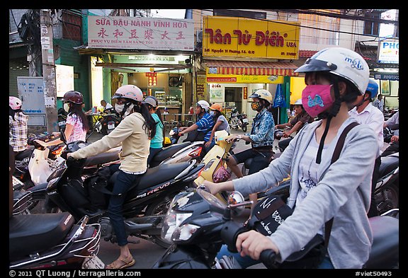 Commuters on motorcyles in stopped traffic. Ho Chi Minh City, Vietnam (color)