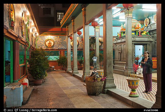 Woman in prayer, inside gallery, Mariamman Hindu Temple. Ho Chi Minh City, Vietnam (color)