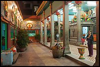 Woman in prayer, inside gallery, Mariamman Hindu Temple. Ho Chi Minh City, Vietnam (color)