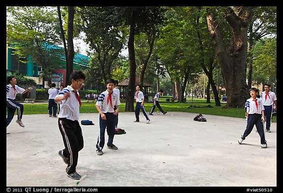 Schoolboys playing a feet badminton game, Cong Vien Van Hoa Park. Ho Chi Minh City, Vietnam (color)