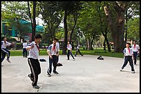 Schoolboys playing a feet badminton game, Cong Vien Van Hoa Park. Ho Chi Minh City, Vietnam (color)