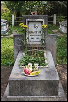 Tomb with fruit and refreshments offering. Ben Tre, Vietnam