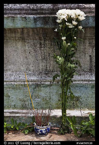 Incense and flowers next to tomb. Ben Tre, Vietnam (color)