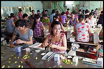 Workers wrapping up coconut candy. Ben Tre, Vietnam (color)