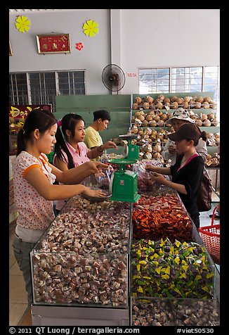 Women packing coconut candy for sale. Ben Tre, Vietnam (color)
