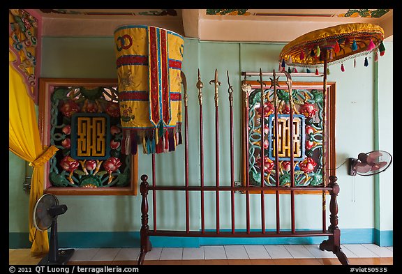 Rack with lamp, unbrella, lances, Saigon Caodai temple, district 5. Ho Chi Minh City, Vietnam