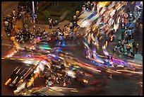 Long exposure traffic trails on busy intersection from above at night. Ho Chi Minh City, Vietnam