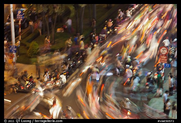 Flow of motorcycle traffic at night from above. Ho Chi Minh City, Vietnam (color)