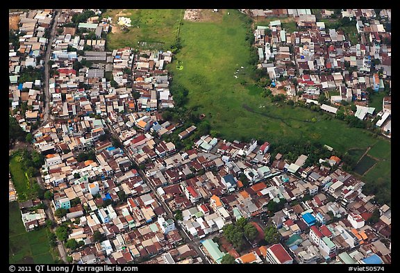 Aerial view of houses and fields on the outskirts of the city. Ho Chi Minh City, Vietnam (color)