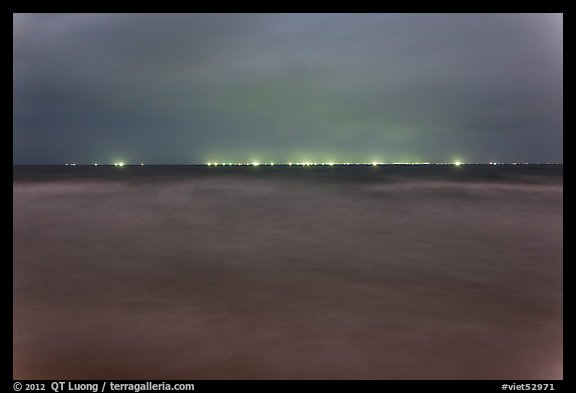 South China Sea at night with lights of fishing boats on horizon. Mui Ne, Vietnam (color)