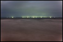 South China Sea at night with lights of fishing boats on horizon. Mui Ne, Vietnam (color)