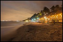 Beach bordered by resorts at night. Mui Ne, Vietnam (color)