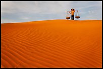 Woman on top of red sand dunes. Mui Ne, Vietnam ( color)