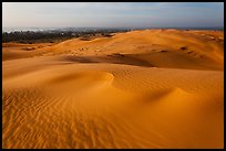 Mui Ne sand dunes, town in the distance. Mui Ne, Vietnam (color)