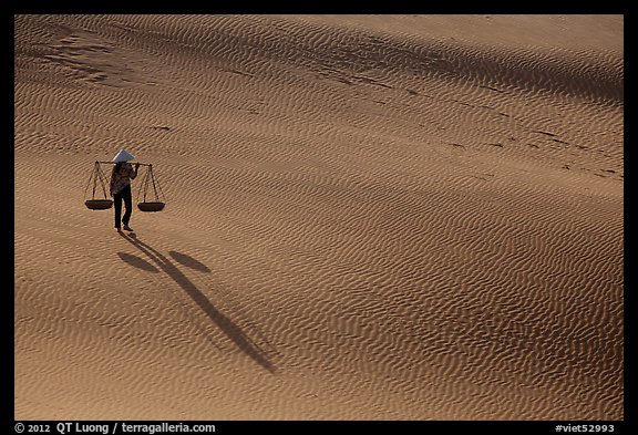 Shadows of woman on dune field. Mui Ne, Vietnam