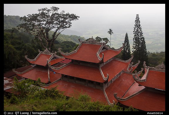 Temple rooftop overlooking plains in mist. Ta Cu Mountain, Vietnam (color)