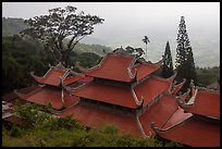 Temple rooftop overlooking plains in mist. Ta Cu Mountain, Vietnam ( color)