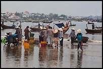 Fishing activity reflected on wet beach. Mui Ne, Vietnam (color)