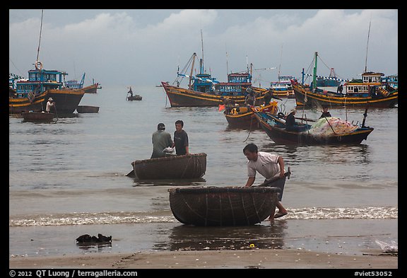 Fishermen on roundboats and fishing fleet. Mui Ne, Vietnam (color)