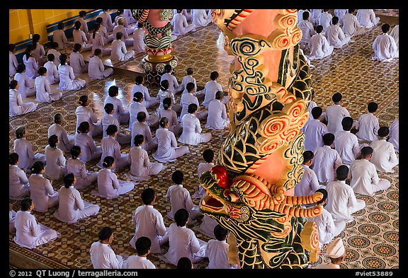 Column and worshippers, Cao Dai Holy See temple. Tay Ninh, Vietnam (color)