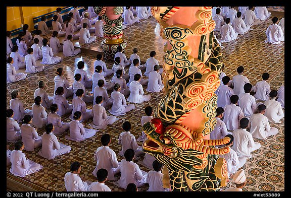 Column and worshippers, Cao Dai Holy See temple. Tay Ninh, Vietnam