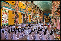 Rows of worshippers in Great Temple of Cao Dai. Tay Ninh, Vietnam (color)