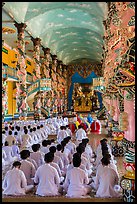 Rows of worshippers in Cao Dai Holy See. Tay Ninh, Vietnam (color)
