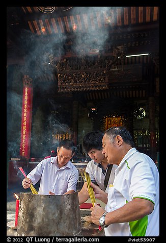 Worshippers burning incense, Thien Hau Pagoda. Cholon, District 5, Ho Chi Minh City, Vietnam (color)