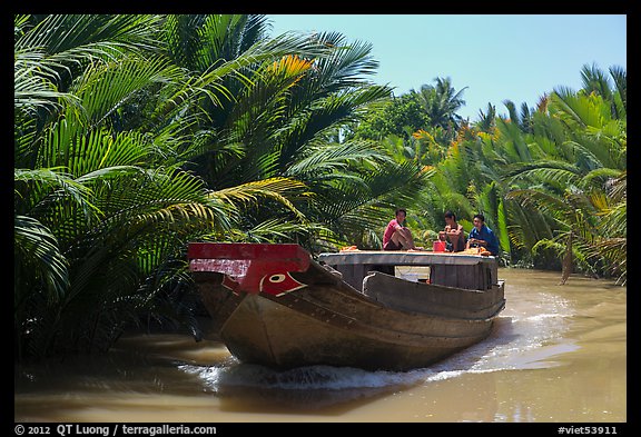 Boat navigating narrow waterway, Phoenix Island. My Tho, Vietnam (color)