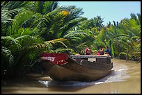 Boat navigating narrow waterway, Phoenix Island. My Tho, Vietnam ( color)