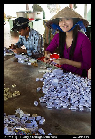 Villagers wrapping coconut candy, Phoenix Island. My Tho, Vietnam (color)