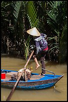 Woman standing in canoe on jungle canal, Phoenix Island. My Tho, Vietnam (color)