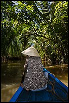 Woman rowing boat under jungle canopy, Phoenix Island. Mekong Delta, Vietnam ( color)