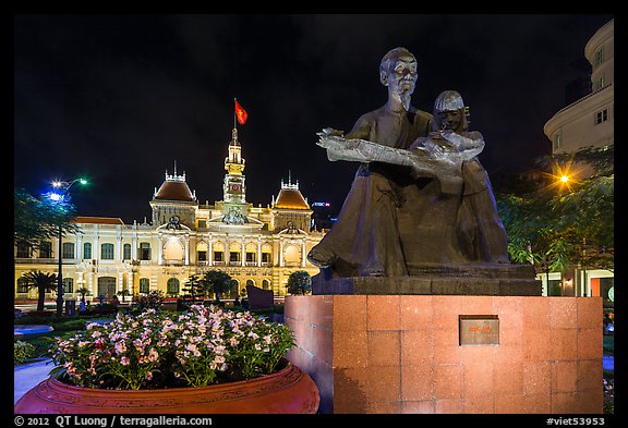 Ho Chi Minh as teacher bronze by Diep Minh Chau and City Hall by night. Ho Chi Minh City, Vietnam (color)