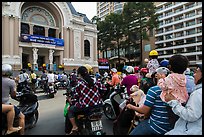Families gather on moterbikes to watch musical performance. Ho Chi Minh City, Vietnam ( color)